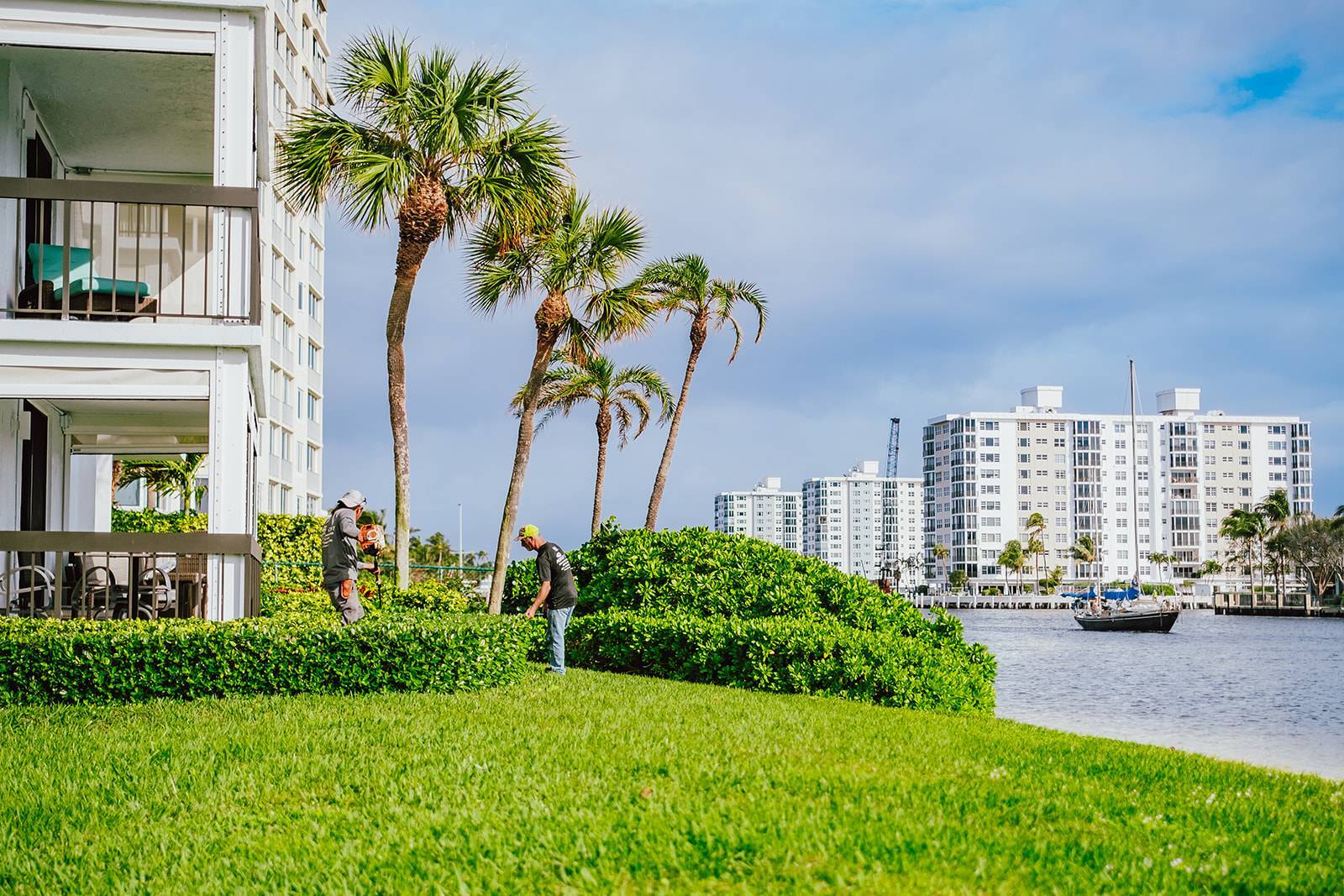Commercial landscape maintenance crews servicing an HOA property in Boynton Beach, FL-1