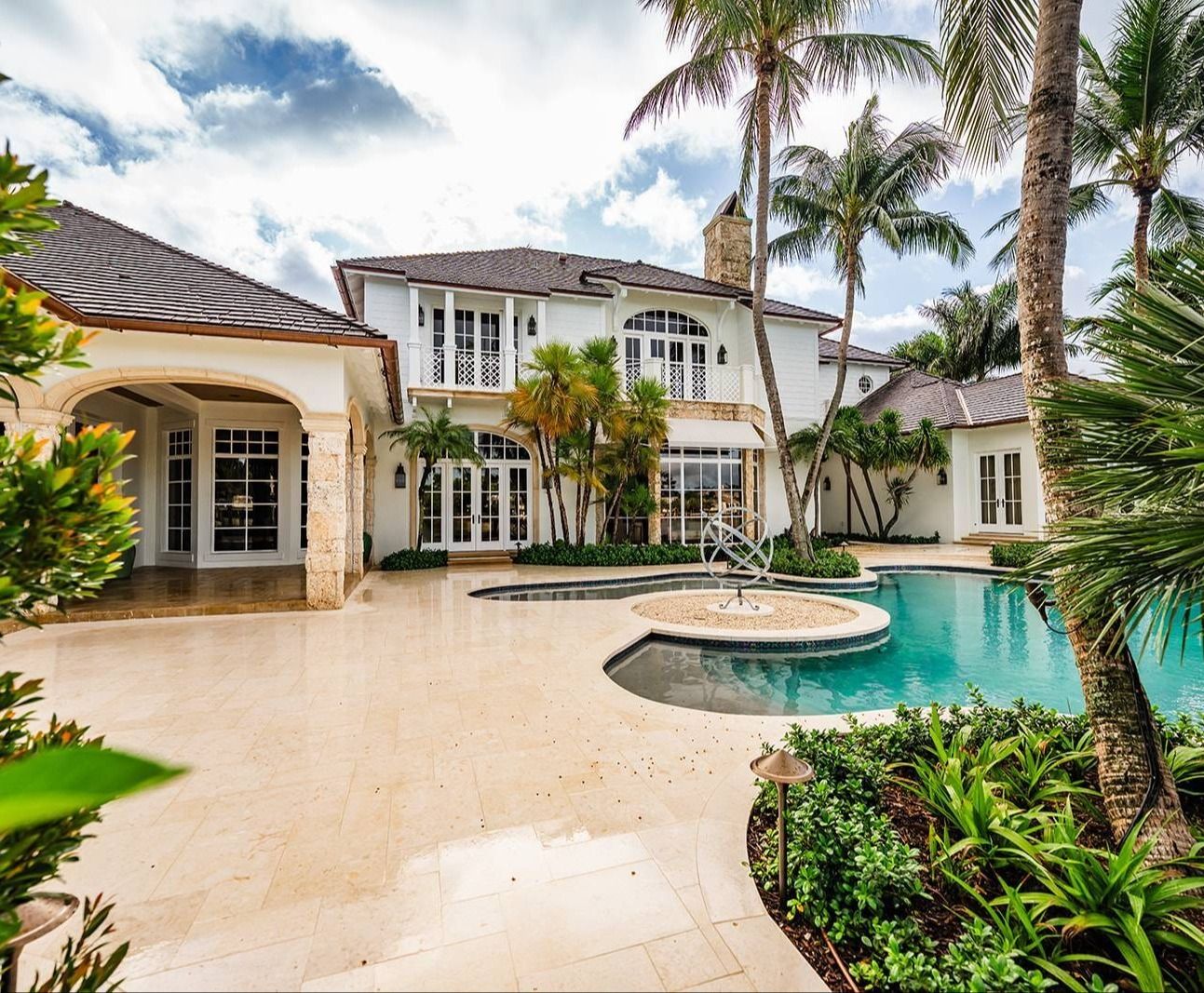 Custom pool and spa with landscape enhancements along waterfront property in Boynton Beach, FL Custom pool and spa with landscape enhancements along waterfront property in Boynton Beach, FL