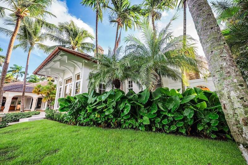 Waterfront estate with palm trees, pool, and professional landscape company work in Manalapan, FL-2
